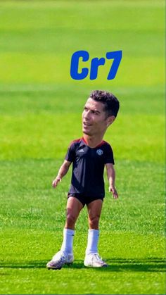 a young man standing on top of a lush green field next to a soccer ball