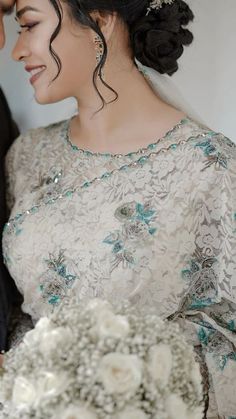 a bride and groom smile at each other