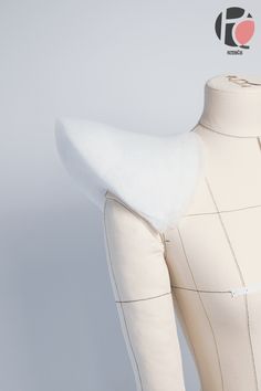 a white mannequin with a piece of fabric on it's back