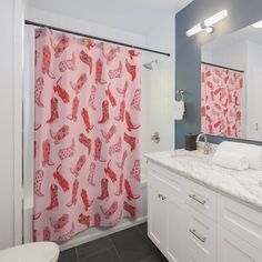 a bathroom with a pink shower curtain next to a white toilet