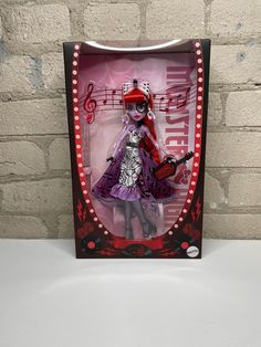 a doll in a box with musical notes on the wall behind it and a brick background