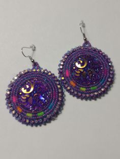 Hand-made beaded earrings: Colors: Purple w/neon colors  Closure: Hook size: 2 inches Handmade Purple Earrings For Festive Occasions, Festive Handmade Purple Earrings, Nickel-free Purple Beaded Earrings With Round Beads, Handmade Rainbow Beaded Earrings For Party, Purple Beaded Earrings As Gift, Round Beaded Earrings With Ear Wire For Party, Handmade Round Beaded Earrings For Festivals, Unique Beaded Earrings With Round Beads For Party, Purple Beaded Round Earrings For Gift