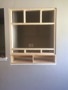 an empty room with some shelves built into the wall