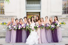 a bride and her bridal party in front of a building