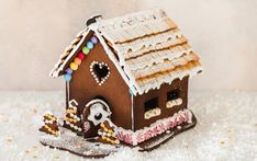 a gingerbread house is decorated with icing and candies for the holiday season