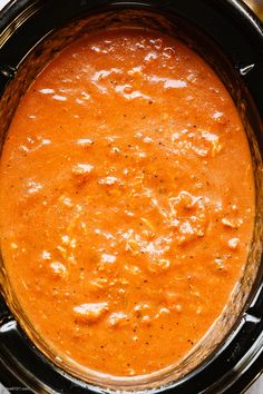 an overhead view of a stew in a crock pot with some seasoning on top