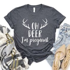 a t - shirt that says oh deer i'm pregnant next to jeans and shoes