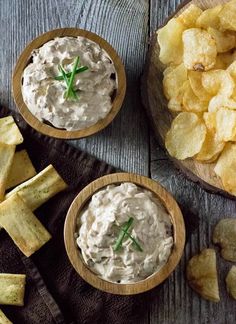 two wooden bowls filled with dip and chips