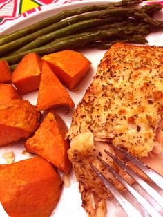 a white plate topped with chicken, potatoes and asparagus