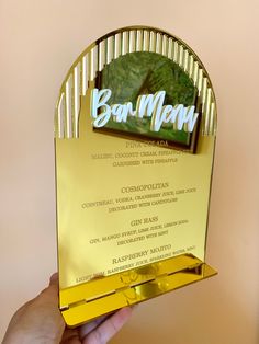 a person holding up a golden award for best restaurant in the world, bon - man