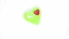 a green heart shaped brooch with a red glitter heart on it's side