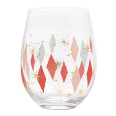 a red and white wine glass with gold stars on the bottom, sitting in front of a white background