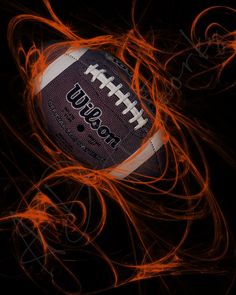 an image of a rugby ball in the air with red swirls around it on a black background