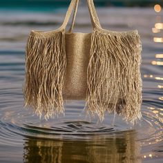 Introducing our stunning Fringed Straw Bag, the perfect accessory for your summer adventures! This handmade crocheted beach bag is completely hand-knitted using Natural paper rope raffia.  This Large Shoulder Bag is hand-woven with intricate details to create a one-of-a-kind piece. Ideal as a Shopping Bag or for a day at the beach, this Raffia Bag combines style and functionality effortlessly. Embrace the Boho vibes with this Crochet Tote Bag, suitable for any occasion. Whether you're into knitt Chic Summer Bags With Fringe, Chic Summer Fringe Bags, Beige Straw Bag With Fringe For Shopping, Chic Natural Color Bags With Fringe, Beach Shoulder Bag With Tassels, Rectangular Shape, Tassel Crochet Tote Bag For Travel, Casual Beach Bags With Fringe, Crochet Tote Bag With Tassels For Travel, Rectangular Beach Bags With Tassels