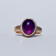 The Beauregarde Ring is named after Violet Beauregarde from Willy Wonka and the Chocolate Factory (the Johnny Depp version). This regal ring features a juicy amethyst that will make you feel like a kid in a chocolate shop again! I hope you love wearing this summery gem and feeling the fun vibes of summer! Details: Size 7 (can be sized up to 7 1/2) Classic 14k gold fill setting with floral band High-quality oval amethyst This item will be shipped within 5 business days. Each piece is handmade by Purple Amethyst Hallmarked Signet Ring, Elegant Purple Amethyst Signet Ring, Fine Jewelry Purple Amethyst Cabochon Ring, Purple Amethyst Cabochon Ring Fine Jewelry, Formal Purple Cabochon Amethyst Ring, Formal Purple Cabochon Ring, Formal Heirloom Amethyst Cabochon Ring, Heirloom Style Purple Amethyst Collectible Ring, Heirloom Purple Amethyst Collectible Ring