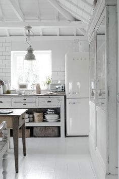 an image of a kitchen with white walls and floors