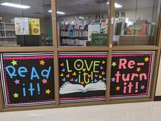 the window display is decorated with books and signs that read, love, re - turn it