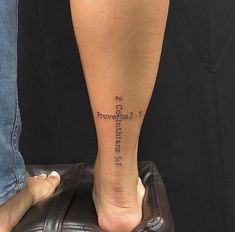 a person with a cross tattoo on their foot