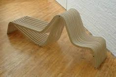 a wooden bench sitting on top of a hard wood floor