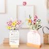 two vases filled with flowers on top of a wooden table