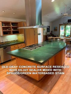 a large kitchen with green counter tops and stainless steel stove top oven in the center