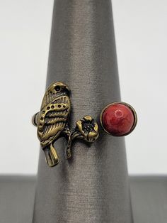 This is a beautiful Native American style bypass ring in brass.  ATTRIBUTES - Unsigned, but appears artisan made in Native American style - Brass - non magnetic  - Features a bird (falcon?) with a flower and red stone which appears to be dyed howlite, a semiprecious gemstone  - Ornate twist on each side - Lovely condition with minor wear from gentle use  MEASUREMENTS - Size 6 3/4 on the mandrel - Main portion measures 0.70" wide x 0.60" tall at the bird CONDITION - Excellent GENTLY USED conditio Adjustable Red Nature-inspired Jewelry, Rustic Red Jewelry As A Gift, Rustic Red Jewelry For Gifts, Artisan Jewelry Handmade, American Pattern, Native American Style, Jewelry Beautiful, Bypass Ring, Pattern Glass