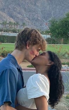 a young man and woman kissing each other