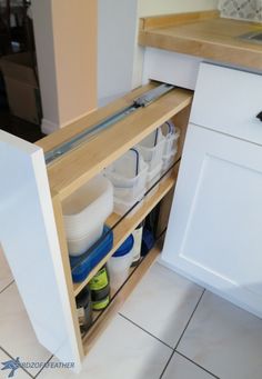 an open cabinet in a kitchen filled with dishes