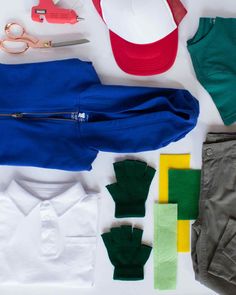 clothes and accessories laid out on top of each other, including baseball cap, gloves, t - shirt