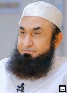 a close up of a person with a long beard and wearing a white hat,