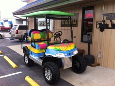 a colorful golf cart parked in front of a building