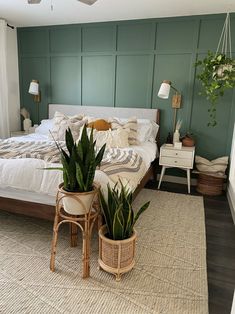 a bedroom with two plants in baskets on the floor