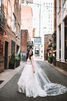 a woman in a wedding dress is walking down the street