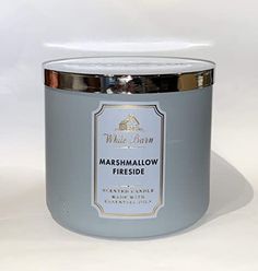 a candle that is sitting on a white surface with the words marshmallow friedie in it