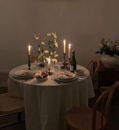 a table with plates and candles on it