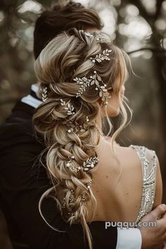 a bride and groom are standing in the woods with their arms around each other, wearing wedding hair combs