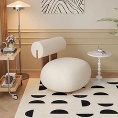 a white chair sitting on top of a black and white rug