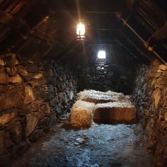 an attic with hay bales in the floor and light shining on the windows above