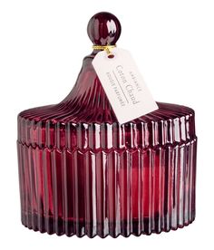 a red glass container with a tag on it