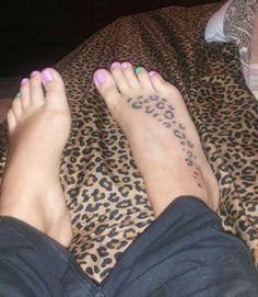 a woman's feet with leopard print on them and her name written on the foot