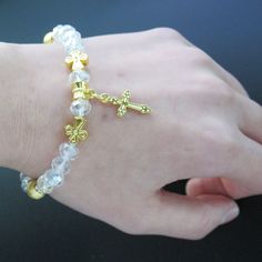 12 PCS Crystal stretch bracelets with gold metal cross charms for first communion, baptism, christening, wedding shower and memories party favor. The high-quality bracelet is made of Crystal clear beads and gold metal charm. 12 Pcs First Communion bracelets for guests. The high-quality bracelets are made of Crystal clear beads and silver metal charm An excellent favor for your guests. A special gift they are sure to cherish. Handmade beaded crystal stretch bracelet with silver cross charms. one Christening Party Favors, Baptism Party Favors, First Communion Favors, Angel Bracelet, Communion Favors, Christening Favors, Crystal Angels, Clear Beads, Metal Cross