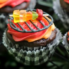 some cupcakes with gummy bears on top of them