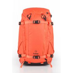 an orange backpack sitting on top of a white floor