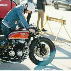 a man sitting on the seat of a motorcycle