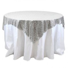 a white table with silver sequins on it