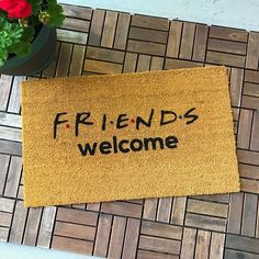 a welcome mat with the words friends welcome on it next to a potted plant