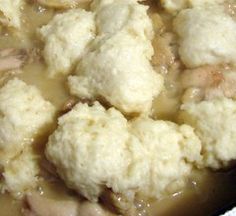 cauliflower and mushrooms are being cooked in a pot on the stove top with gravy