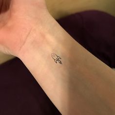 a person with a small tattoo on their arm