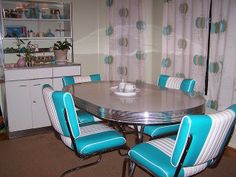 a dining room table with blue chairs around it