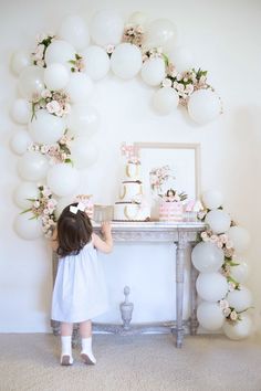 a table with balloons and cake on it